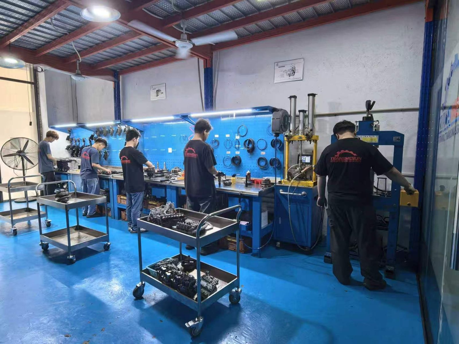 TRANSMESUN rebuild team at the workshop benches